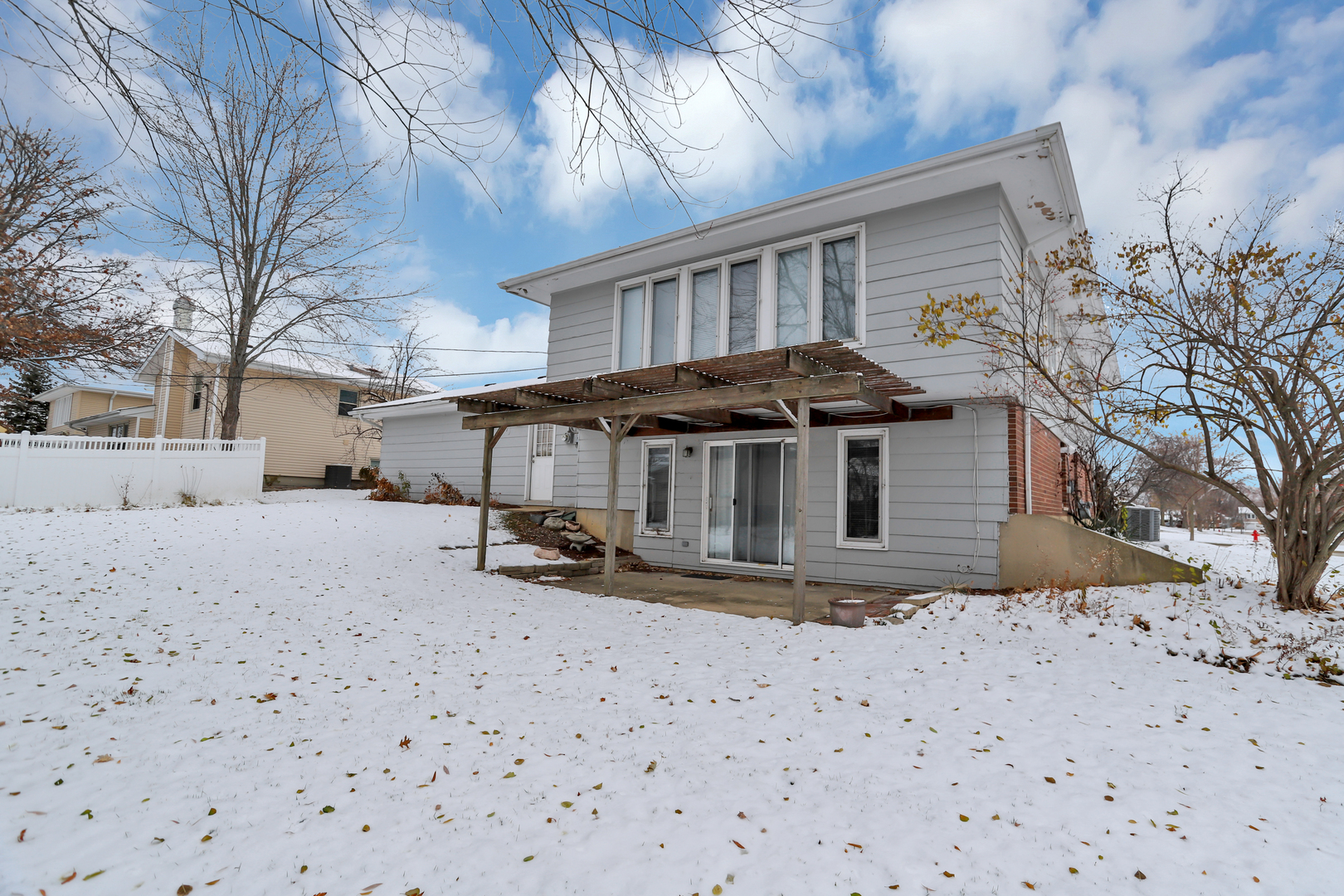 1900 Chippendale Road Hoffman Estates, IL 60169 - Photo 6 of 37 a view of a house with a yard covered in snow