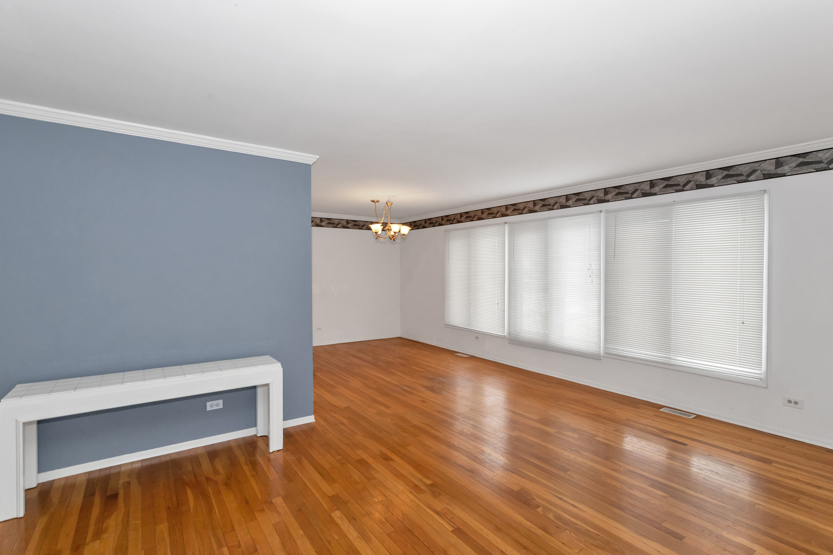 1900 Chippendale Road Hoffman Estates, IL 60169 - Photo 10 of 37 a view of an empty room with wooden floor and a window