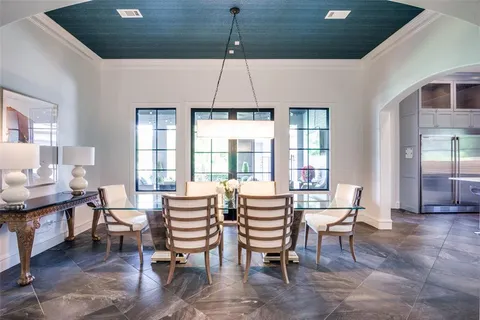 a dining room with furniture a chandelier and wooden floor