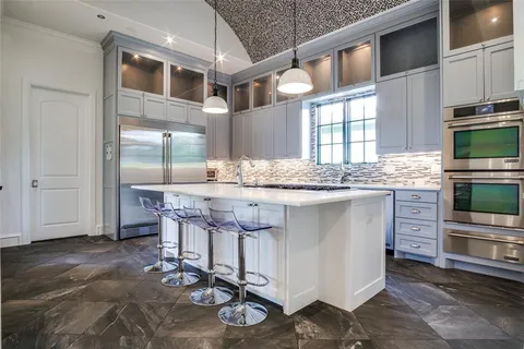 a kitchen with stainless steel appliances granite countertop a stove and cabinets