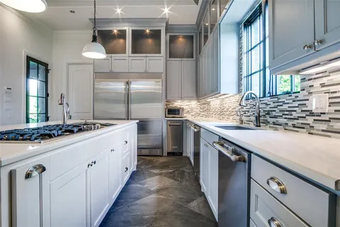 a kitchen with stainless steel appliances granite countertop a sink and a stove