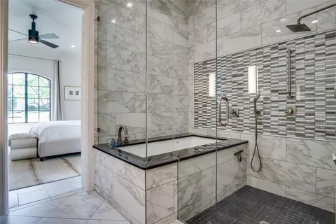 a bathroom with a granite countertop sink a bathtub and shower