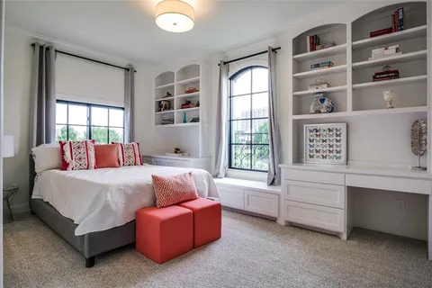 a bedroom with furniture and a window