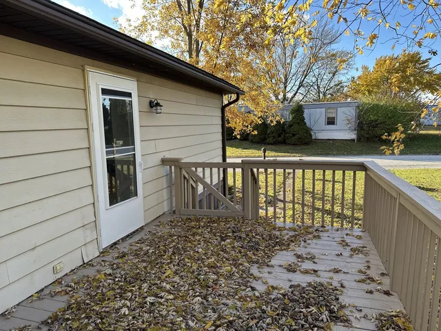 a view of a house with a wooden fence