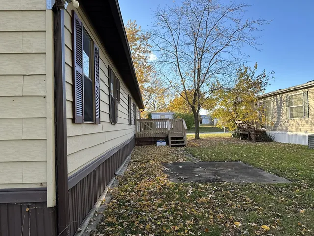 a view of house with backyard and trees
