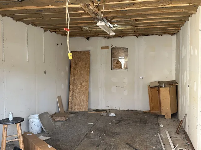 a view of a room with table and chairs