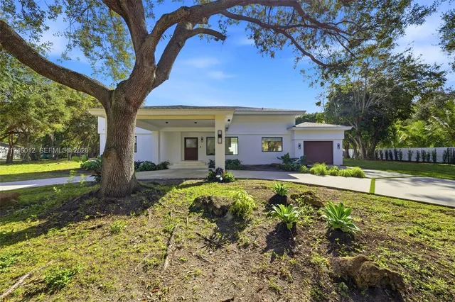 a front view of a house with swimming pool having outdoor seating