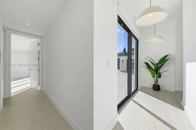 a view of entryway with paintings on the wall