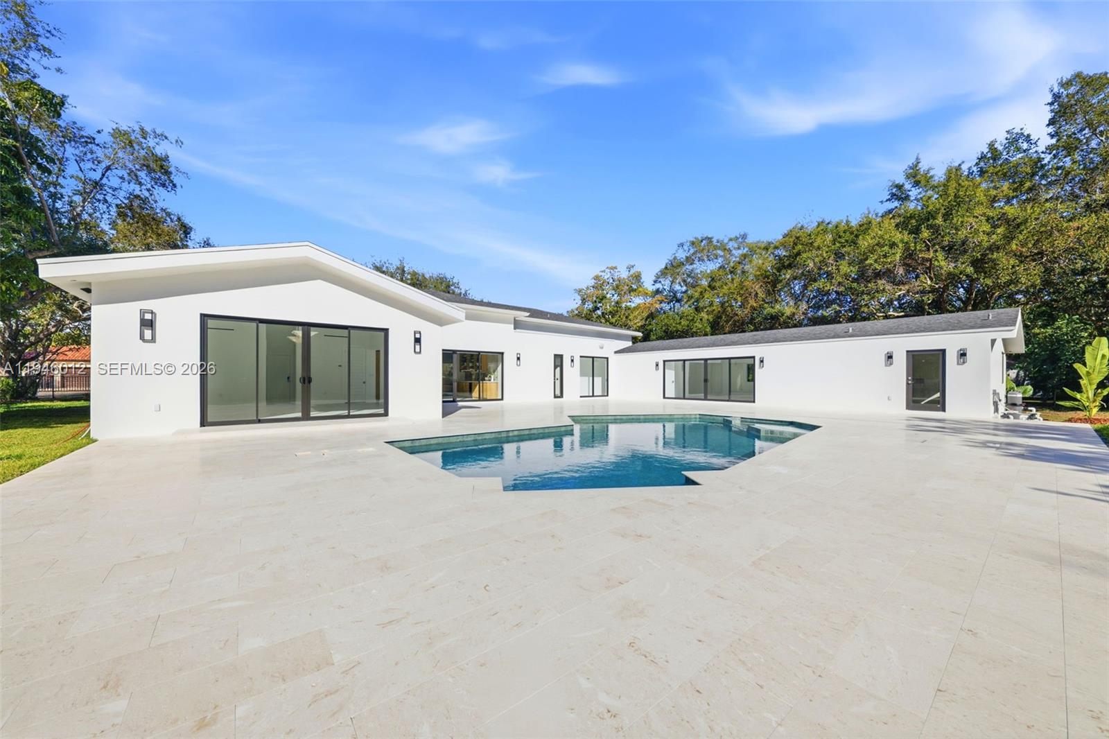 8800 Southwest 118th Street Miami, FL 33176 - Photo 42 of 44 a front view of a house with a yard and garage