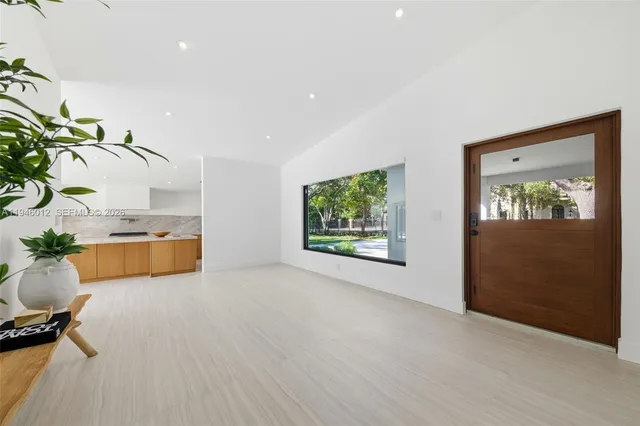 a view of a kitchen with furniture and a potted plant