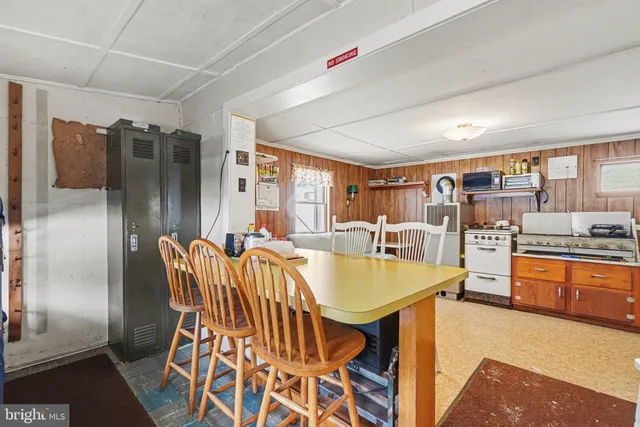 a open kitchen with granite countertop a sink cabinets and stainless steel appliances