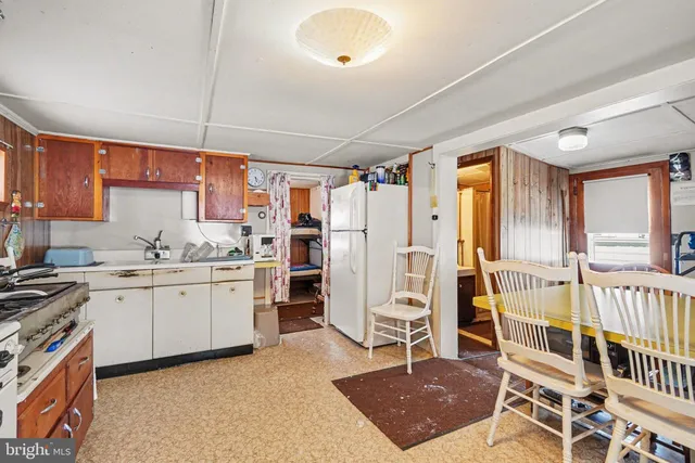 a kitchen with a stove top oven sink and cabinets