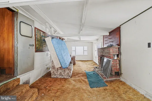 a view of a livingroom with furniture and a fireplace