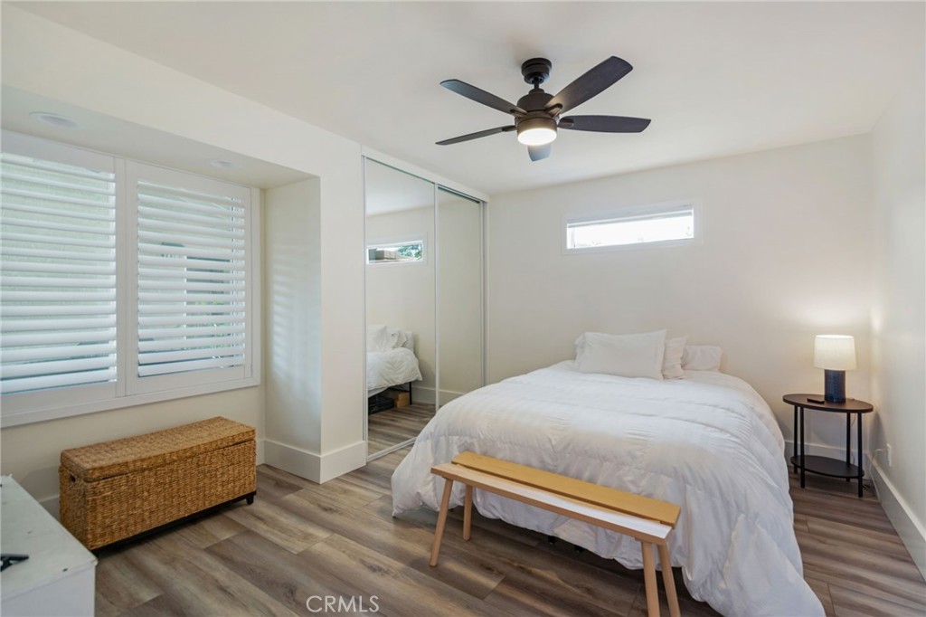 109 Cinnamon Ridge Road Brea, CA 92821 - Photo 6 of 67 Downstairs bedroom right off of main entrance, LVP flooring, ceiling fan with light, plantation shutters and Mirrored closet sliding doors.