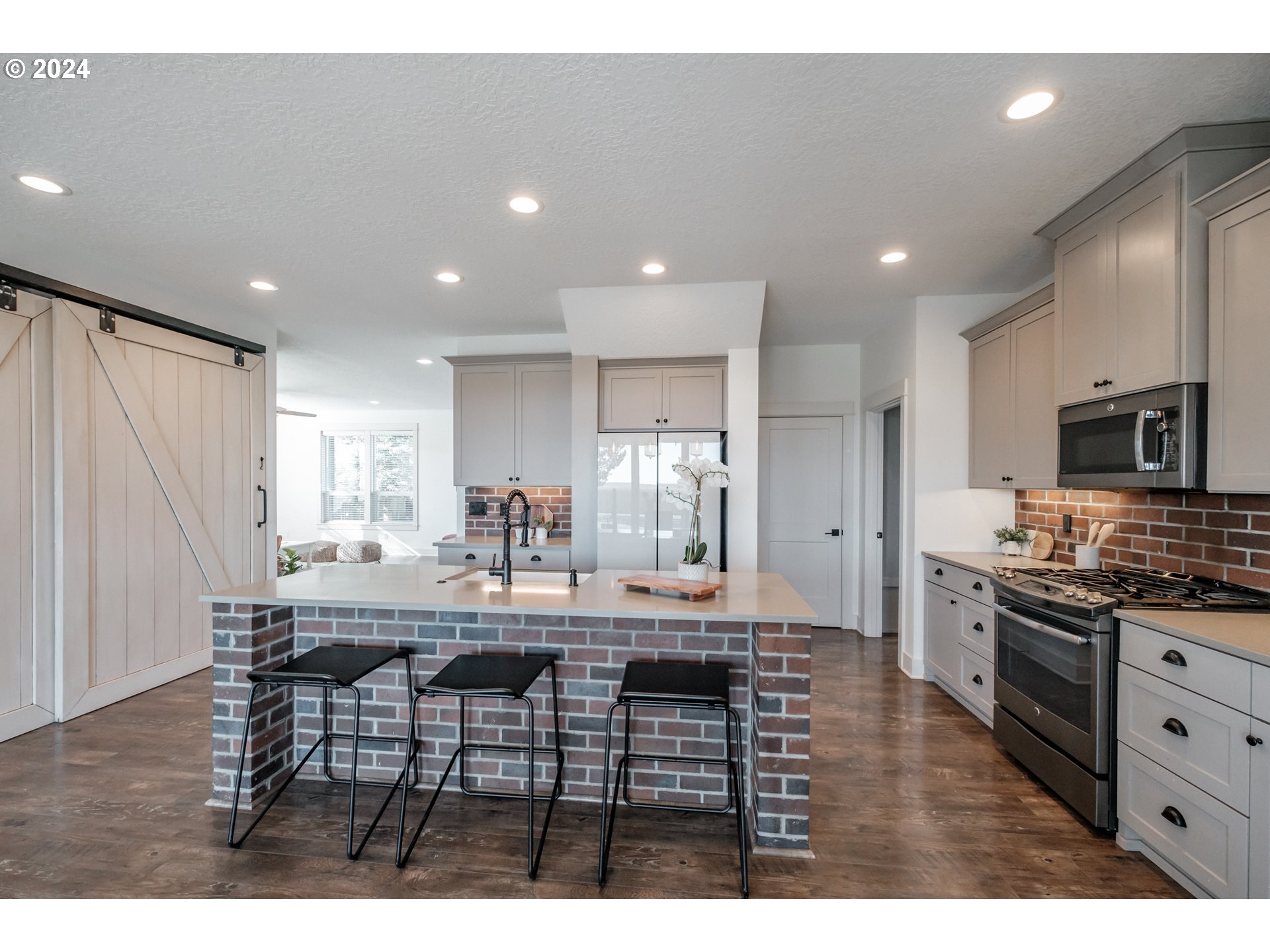 10886 Bethel Road Amity, OR 97101 - Photo 15 of 42 a kitchen with stainless steel appliances kitchen island granite countertop a stove a sink a refrigerator with a dining table and chairs