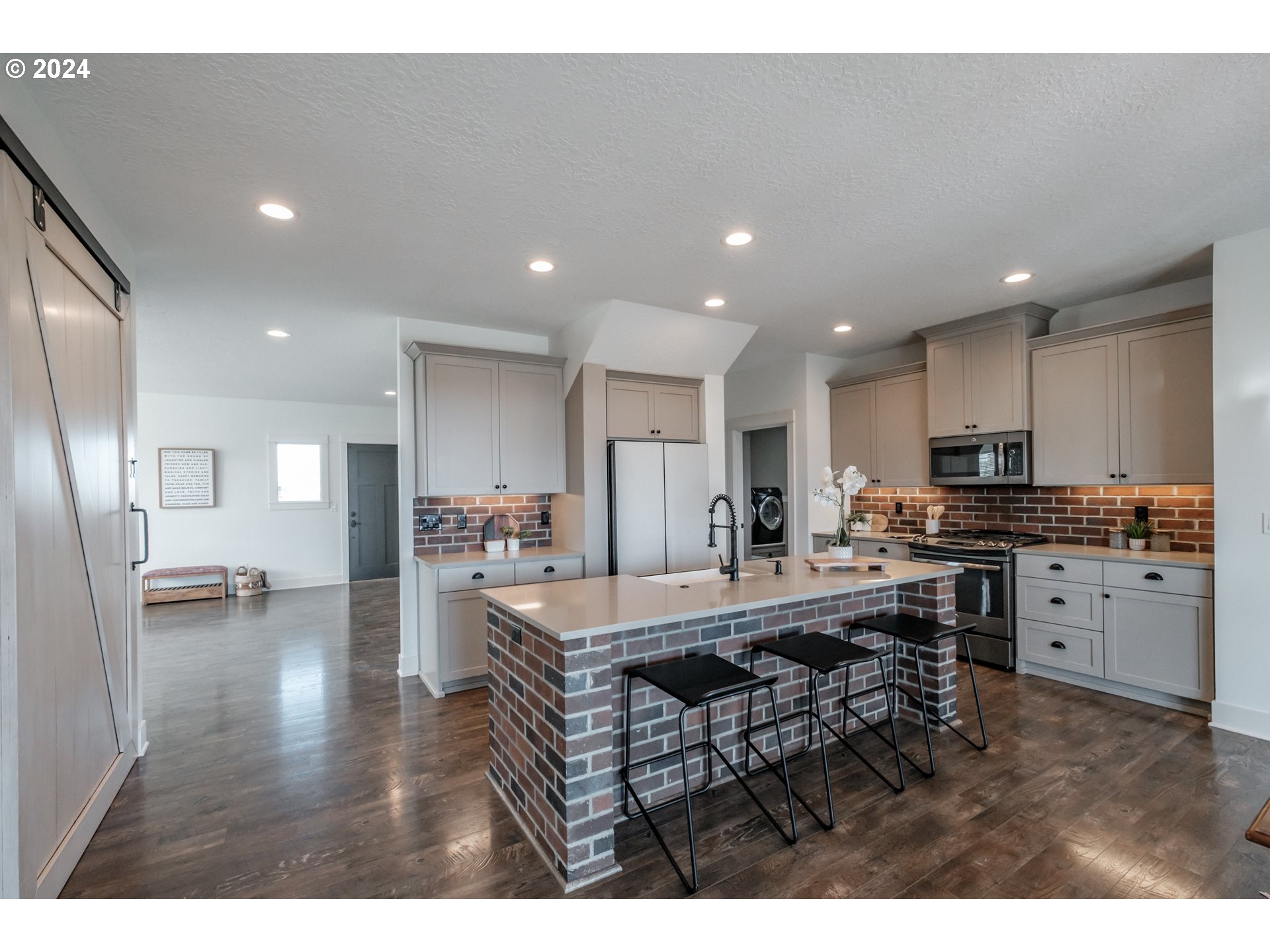 10886 Bethel Road Amity, OR 97101 - Photo 16 of 42 a kitchen with stainless steel appliances granite countertop a refrigerator oven a sink dishwasher and white cabinets with wooden floor