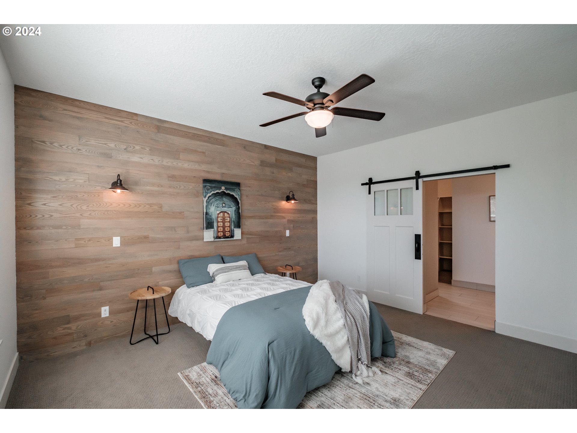 10886 Bethel Road Amity, OR 97101 - Photo 21 of 42 a bedroom with a bed and a chandelier