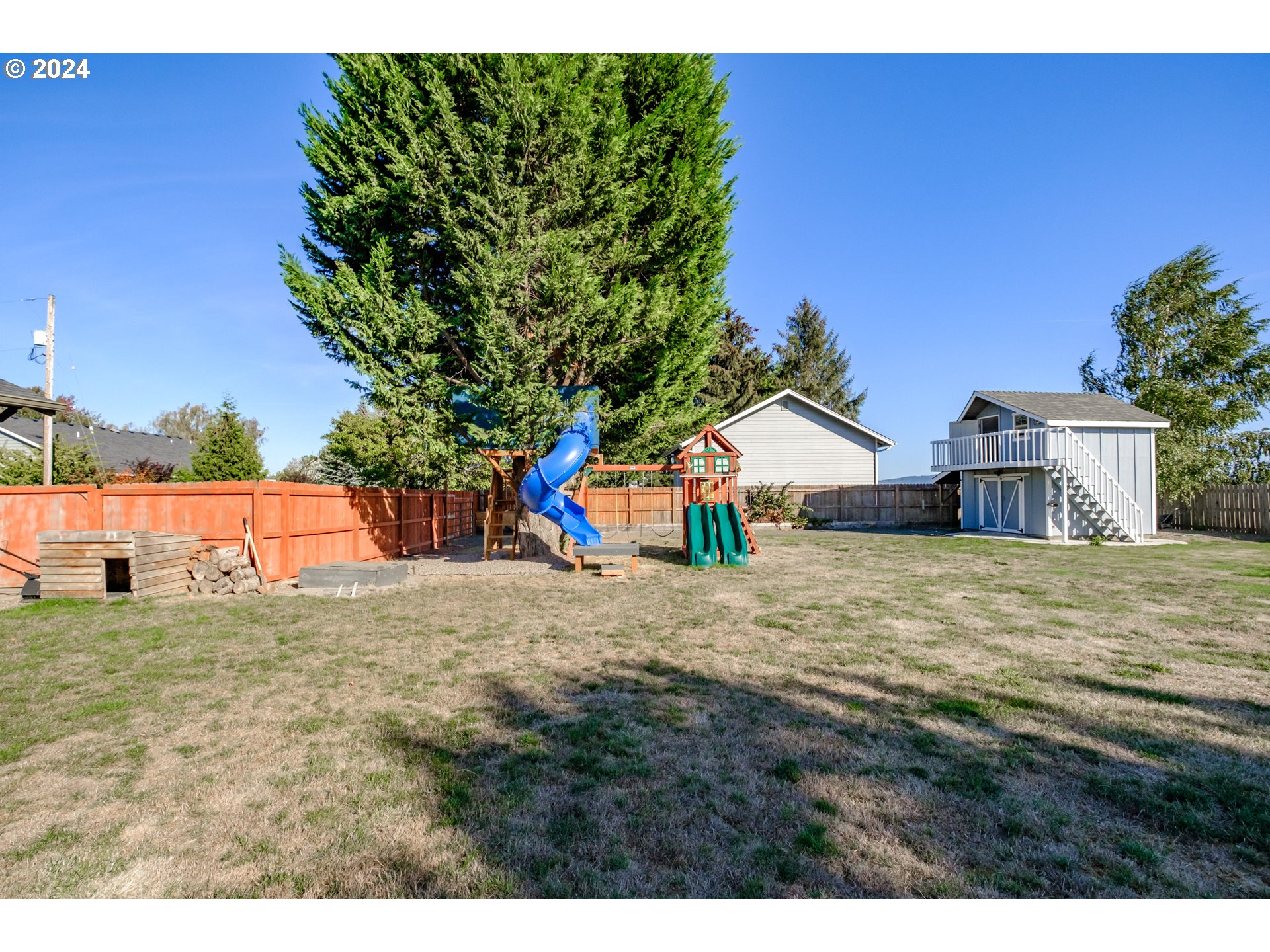 10886 Bethel Road Amity, OR 97101 - Photo 5 of 42 a backyard of a house with a yard and potted plants