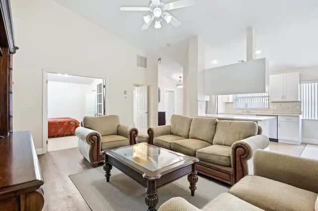 a living room with furniture and a large mirror