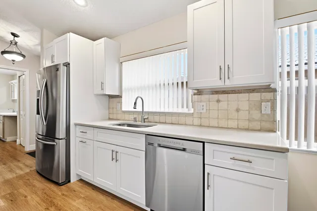 a kitchen with appliances cabinets and a sink