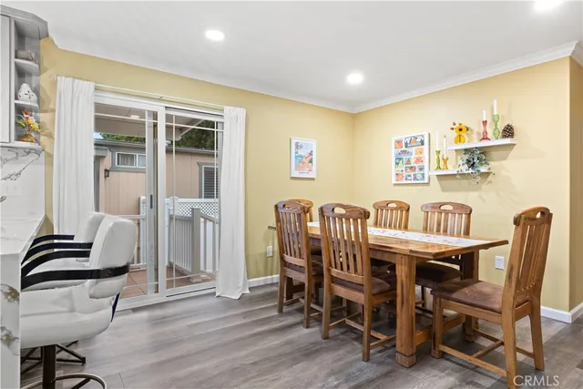 a dining room with furniture and wooden floor