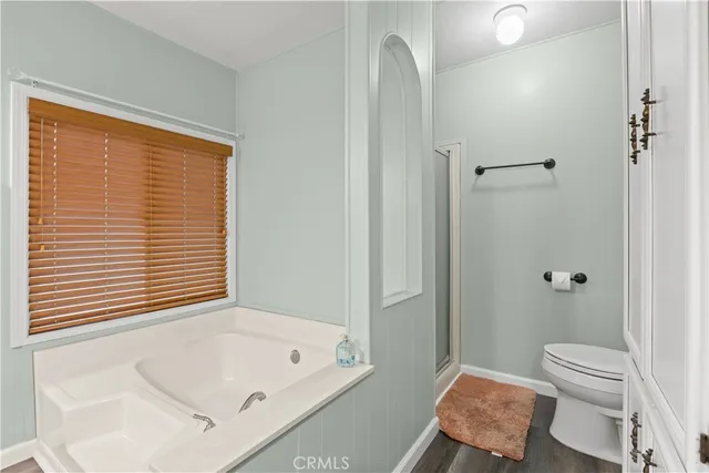 a bathroom with a tub sink and a toilet