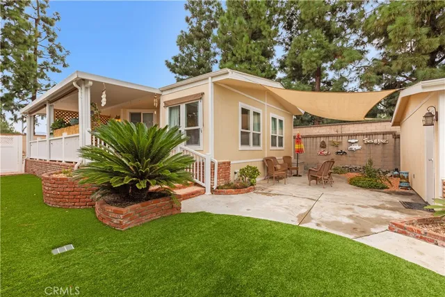 a view of a house with a yard siting area and garden
