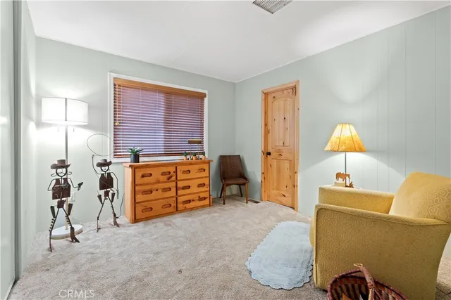 a bedroom with a bed and a lamp on the table