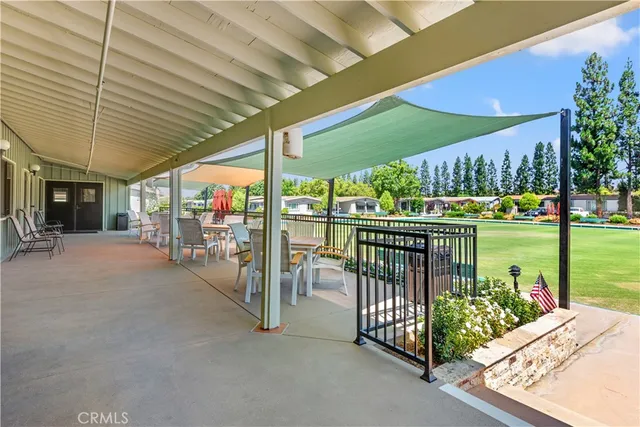a view of a porch with furniture and garden