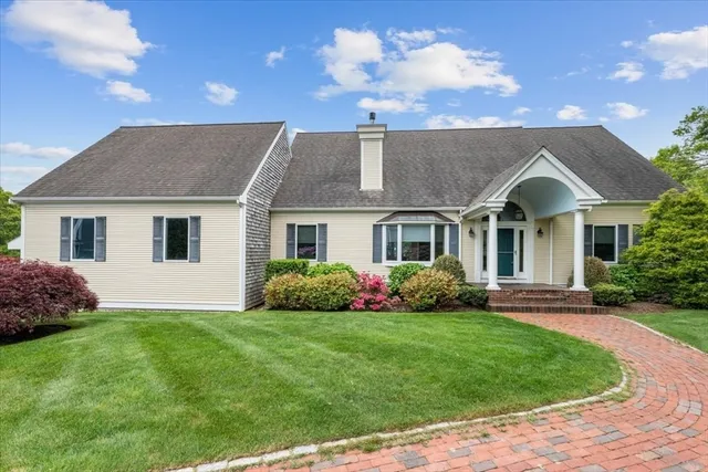 a front view of a house with a garden