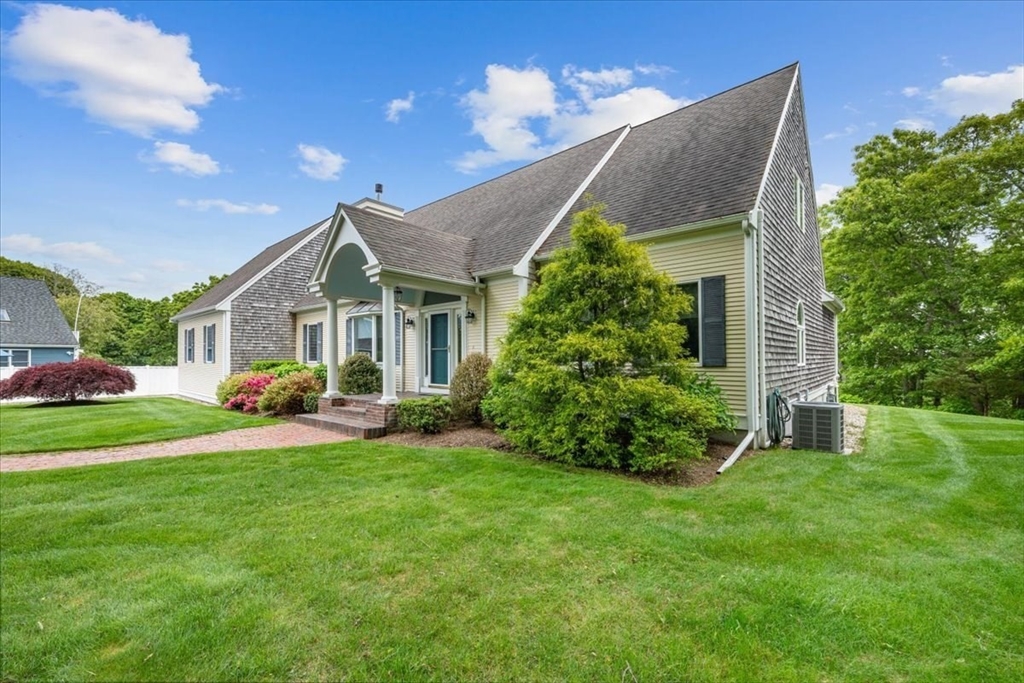 89 Standish Road Bourne, MA 02562 - Photo 3 of 39 a front view of a house with garden and porch