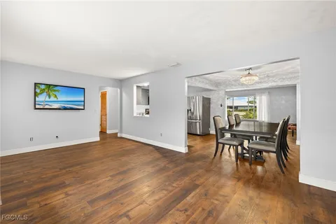 a dining room with furniture and wooden floor