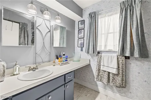 a bathroom with a sink and a mirror