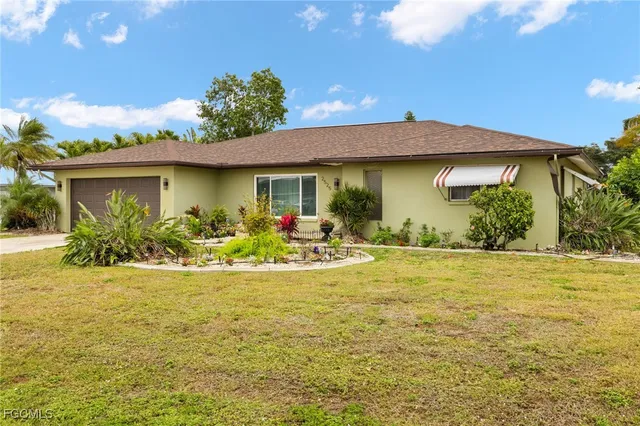 a view of a house with swimming pool patio and a yard
