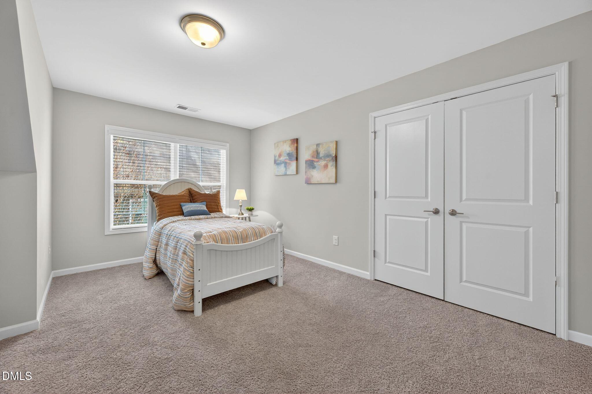 528 Spring Flower Court Cary, NC 27511 - Photo 38 of 51 a bedroom with a bed and a painting on the wall