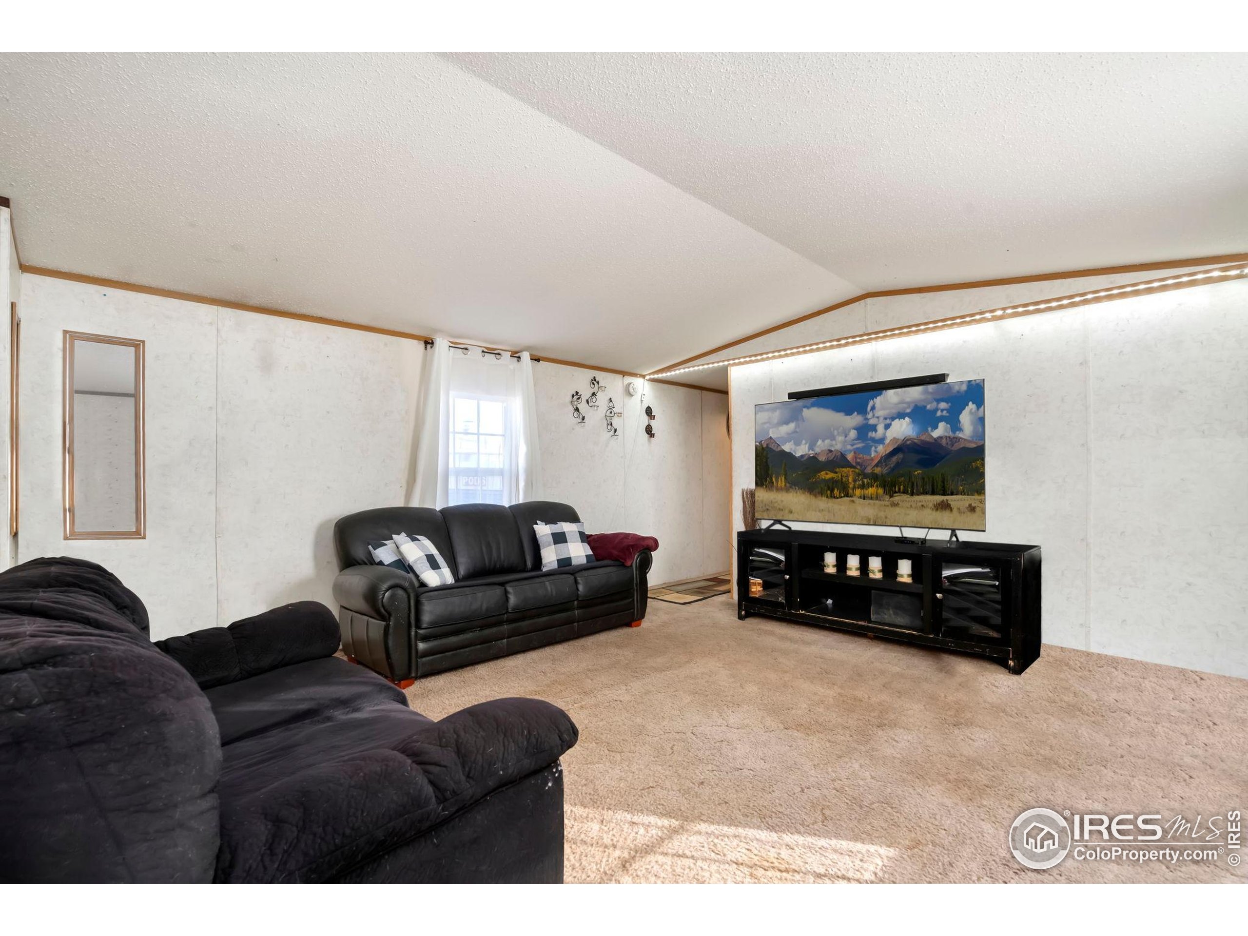 2500 East Harmony Road, Unit 166 Fort Collins, CO 80528 - Photo 11 of 24 a living room with furniture and a flat screen tv