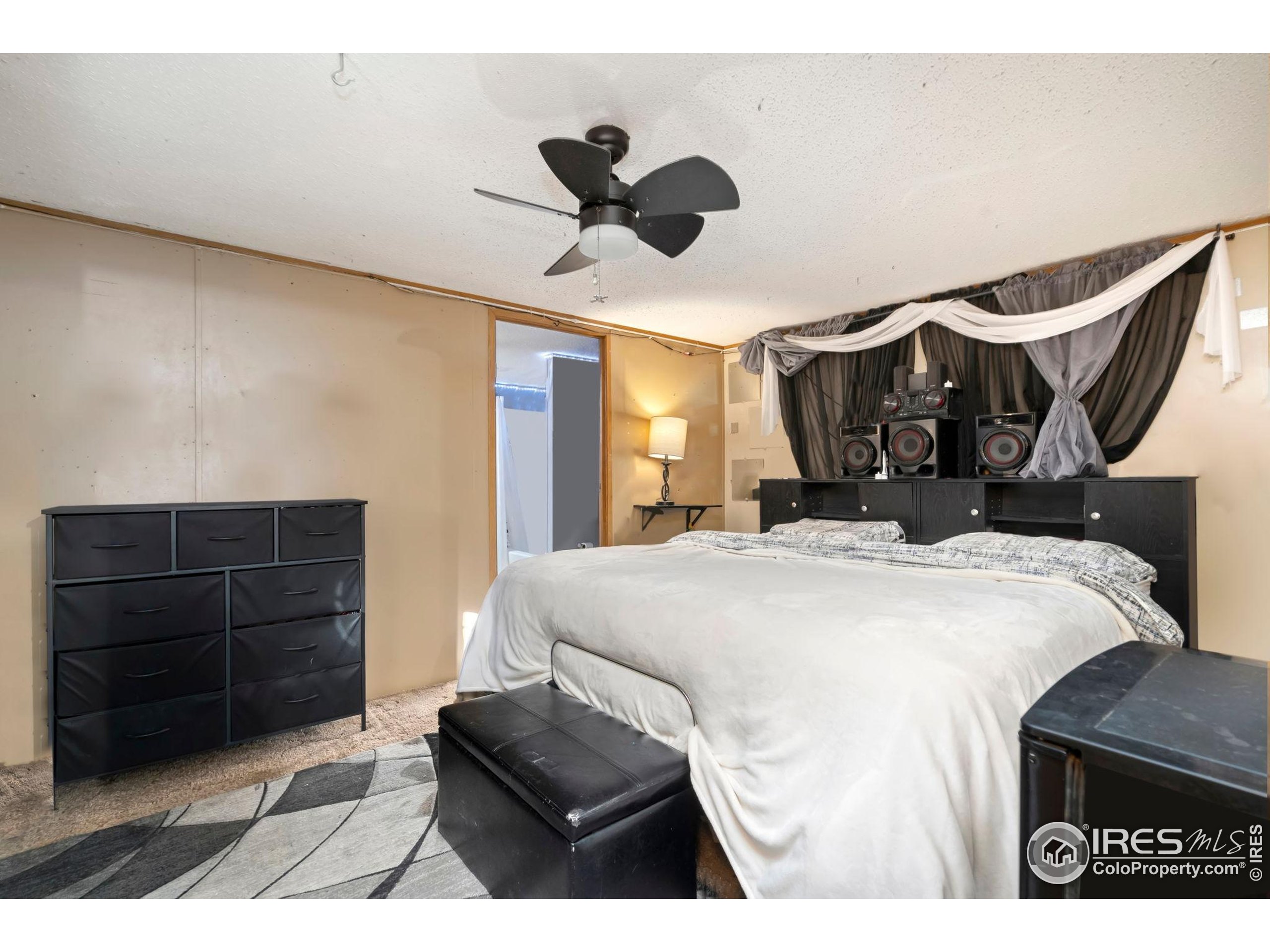 2500 East Harmony Road, Unit 166 Fort Collins, CO 80528 - Photo 14 of 24 a bedroom with a bed and a dresser
