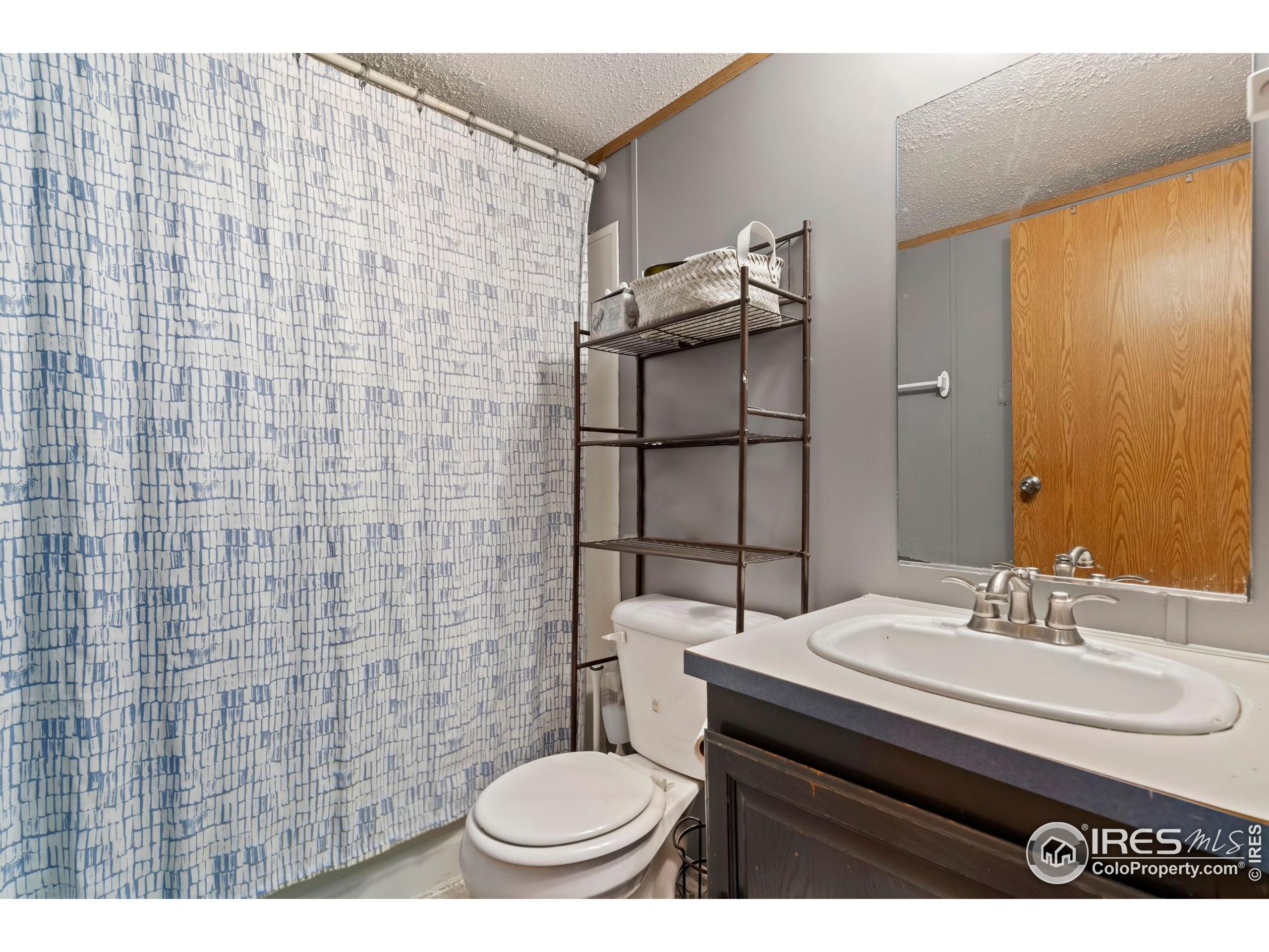 2500 East Harmony Road, Unit 166 Fort Collins, CO 80528 - Photo 17 of 24 a bathroom with a sink a toilet and shower