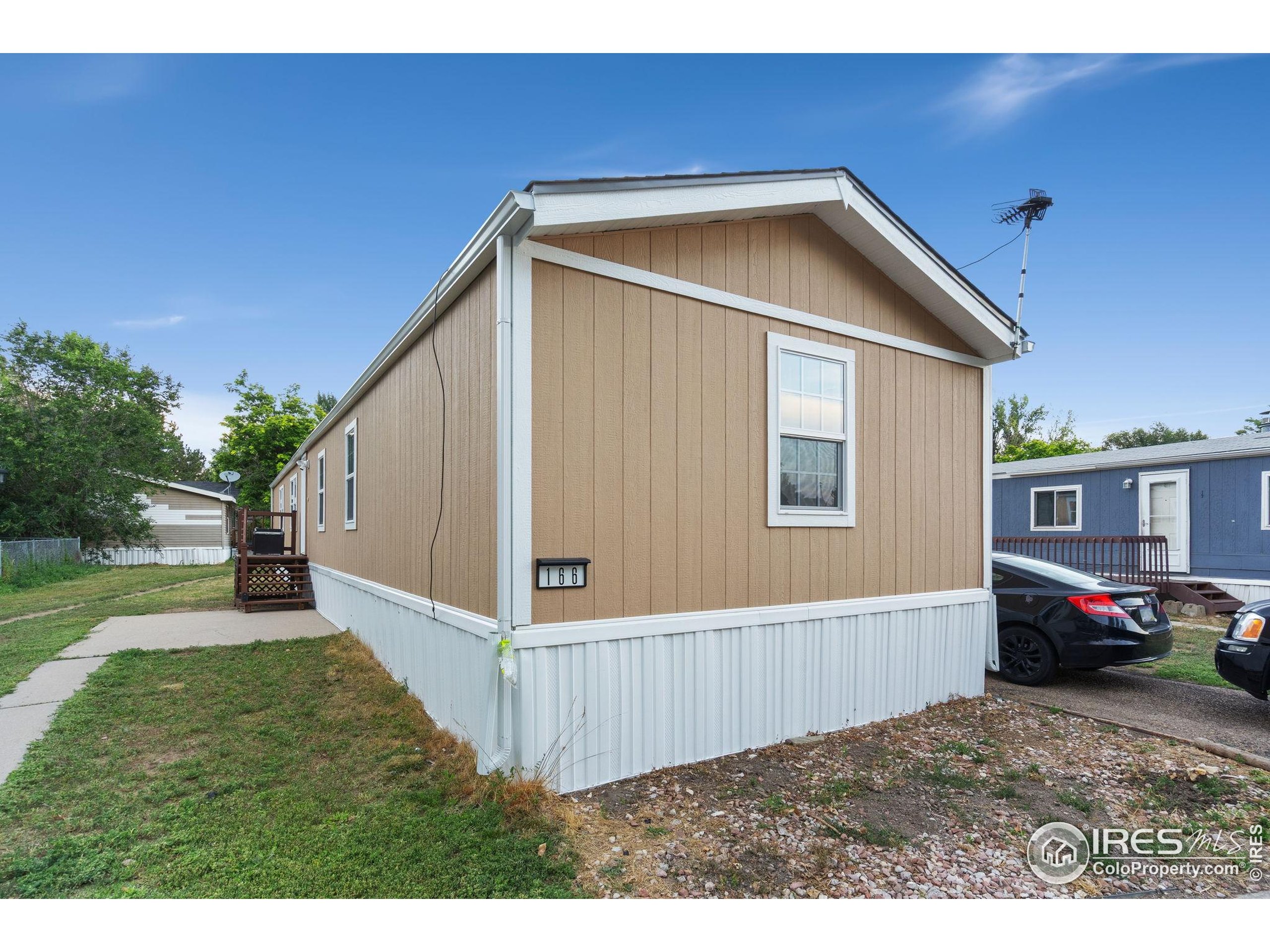 2500 East Harmony Road, Unit 166 Fort Collins, CO 80528 - Photo 20 of 24 a front view of a house with a yard
