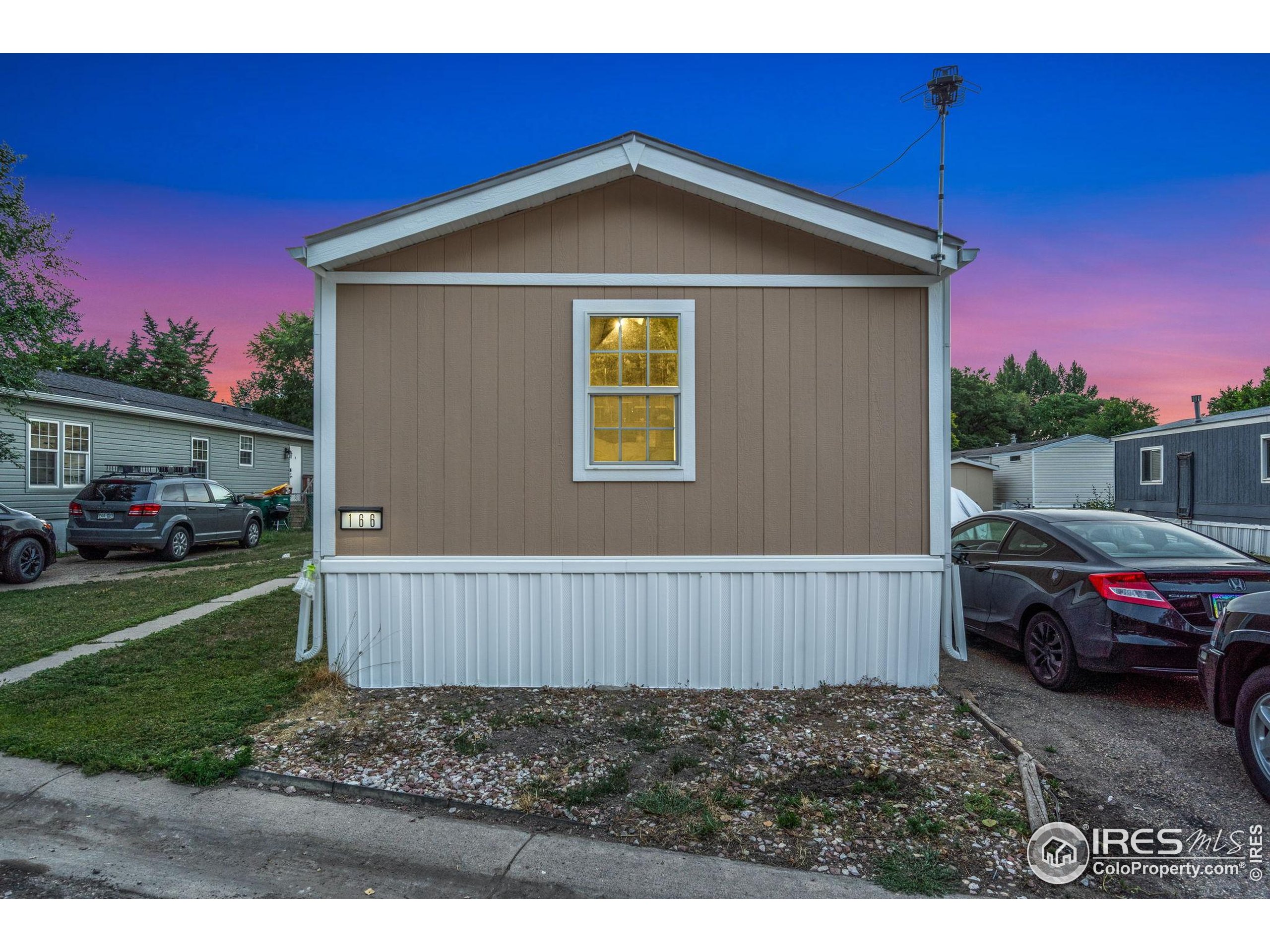 2500 East Harmony Road, Unit 166 Fort Collins, CO 80528 - Photo 2 of 24 a view of a house with a yard