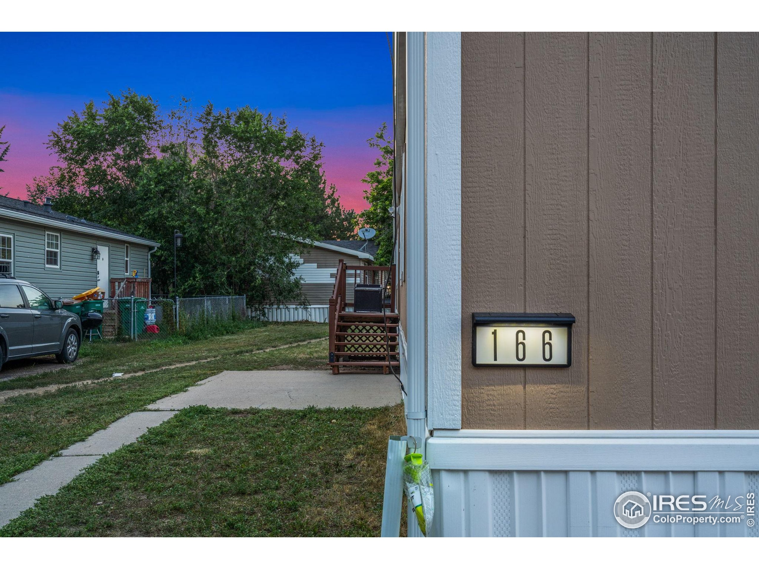 2500 East Harmony Road, Unit 166 Fort Collins, CO 80528 - Photo 3 of 24 a view of a backyard with a garden and trees