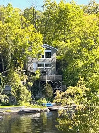 a house with swimming pool in front of it