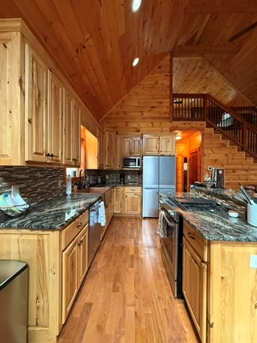5575 Rainbow Springs Road Franklin, NC 28734 - Photo 16 of 35 a kitchen with stainless steel appliances granite countertop a stove a sink and a microwave