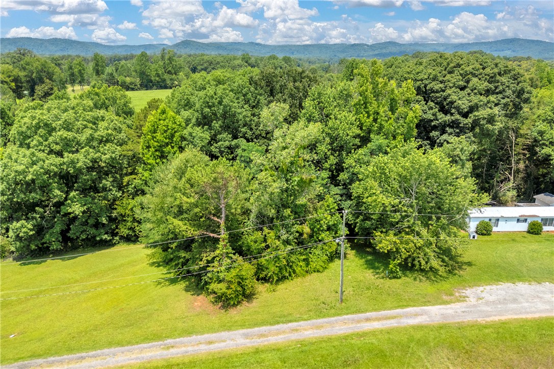 A verdant rural landscape with a distant single-family residence, showcasing a private setting.