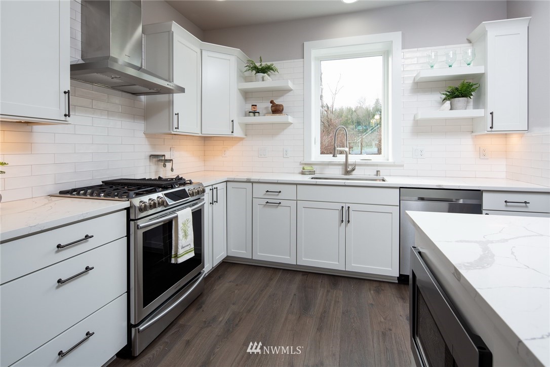 5578 South Church Road Ferndale, WA 98248 - Photo 8 of 36 a kitchen with cabinets appliances a sink and a window