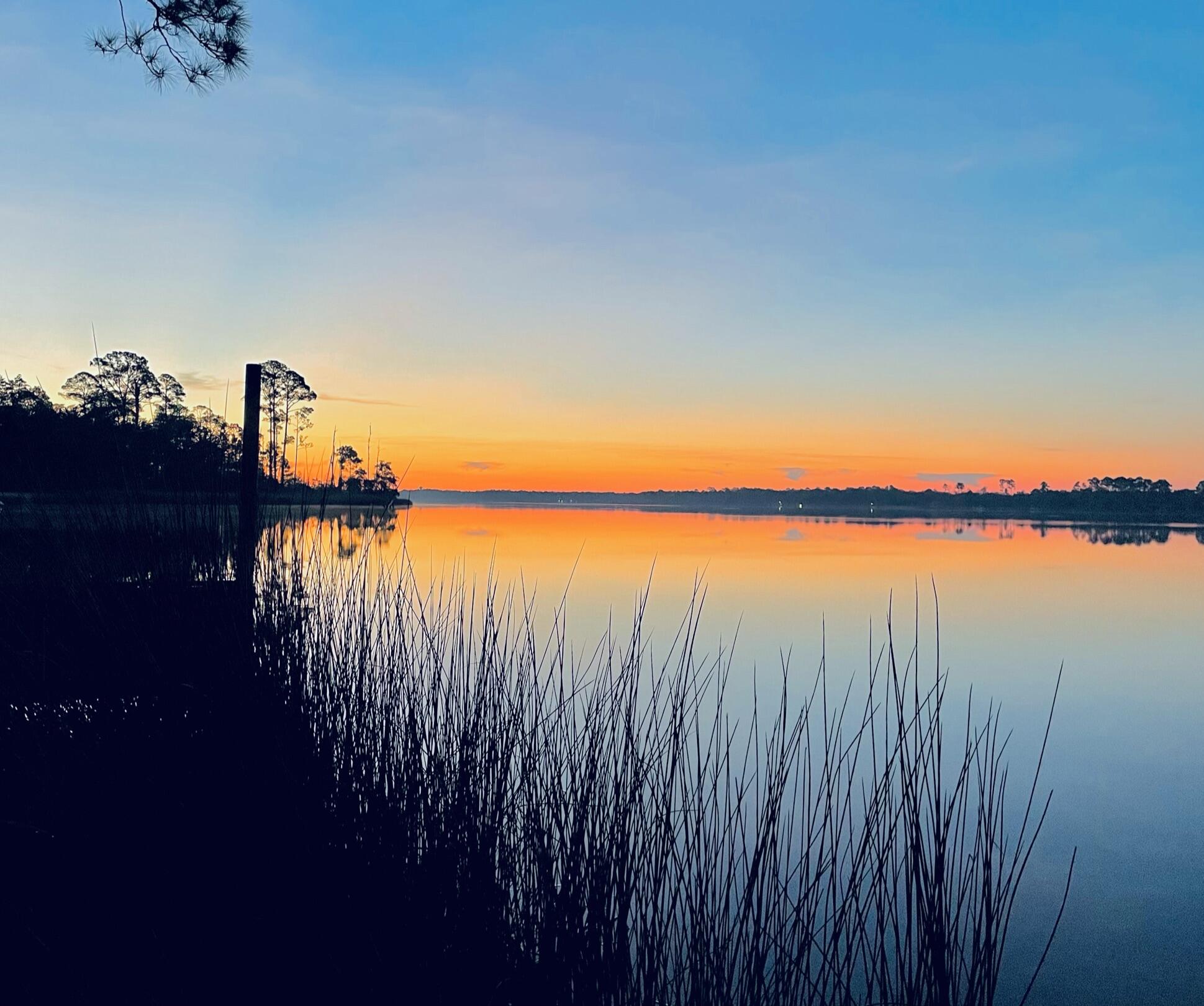 2975 Holley Point Road Navarre, FL 32566 - Photo 11 of 101 a view of a lake with houses in the background