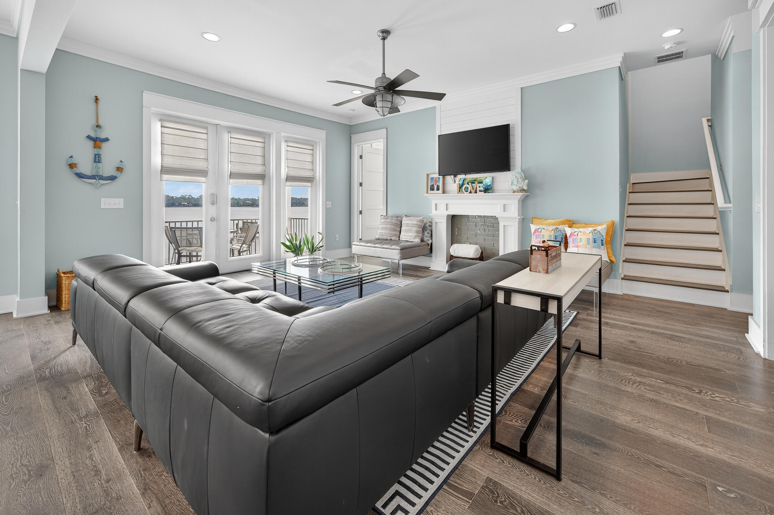 2975 Holley Point Road Navarre, FL 32566 - Photo 20 of 101 a living room with fireplace furniture and a flat screen tv