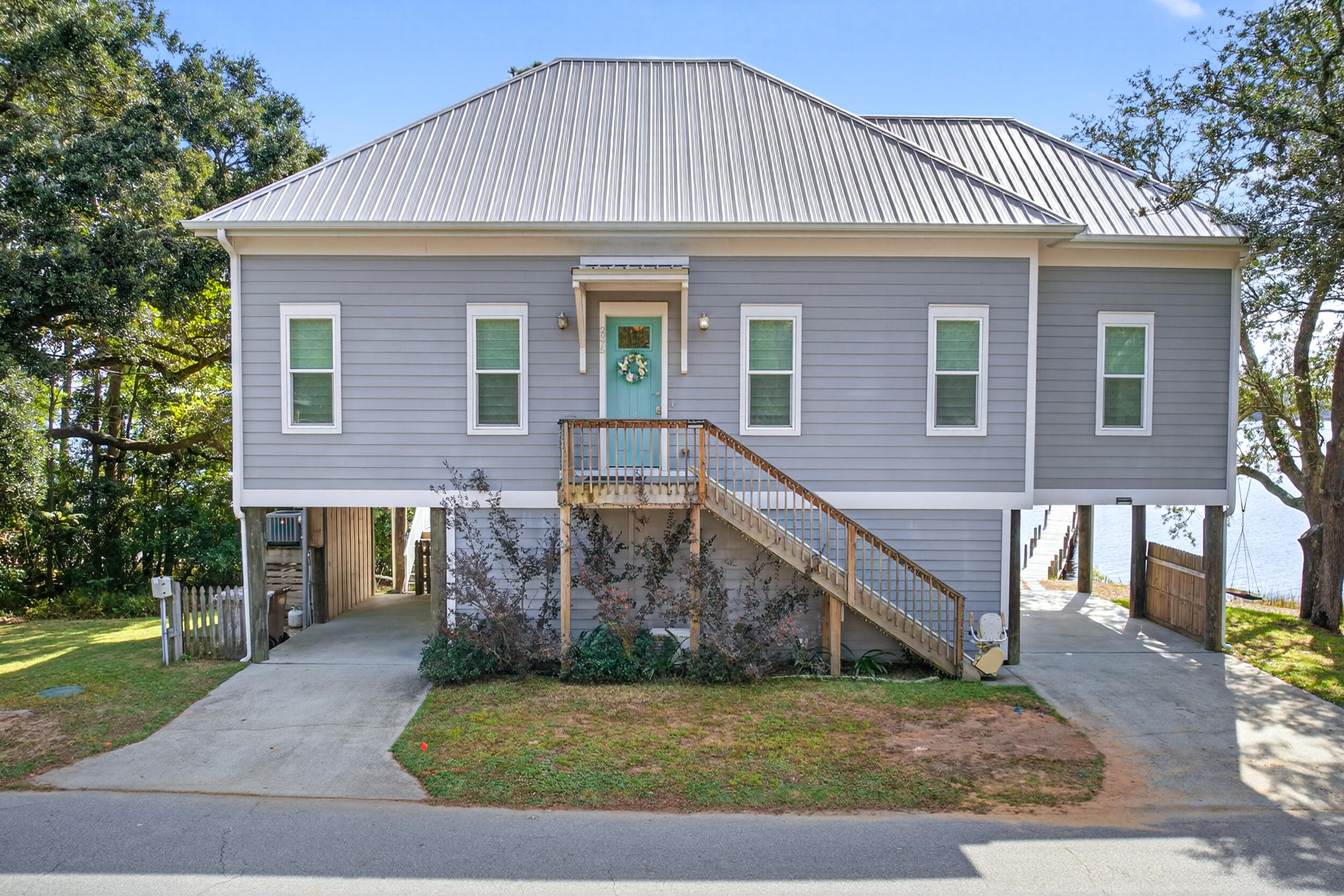 2975 Holley Point Road Navarre, FL 32566 - Photo 2 of 101 a front view of a house with a yard