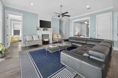 a view of a hallway with wooden floor and entryway
