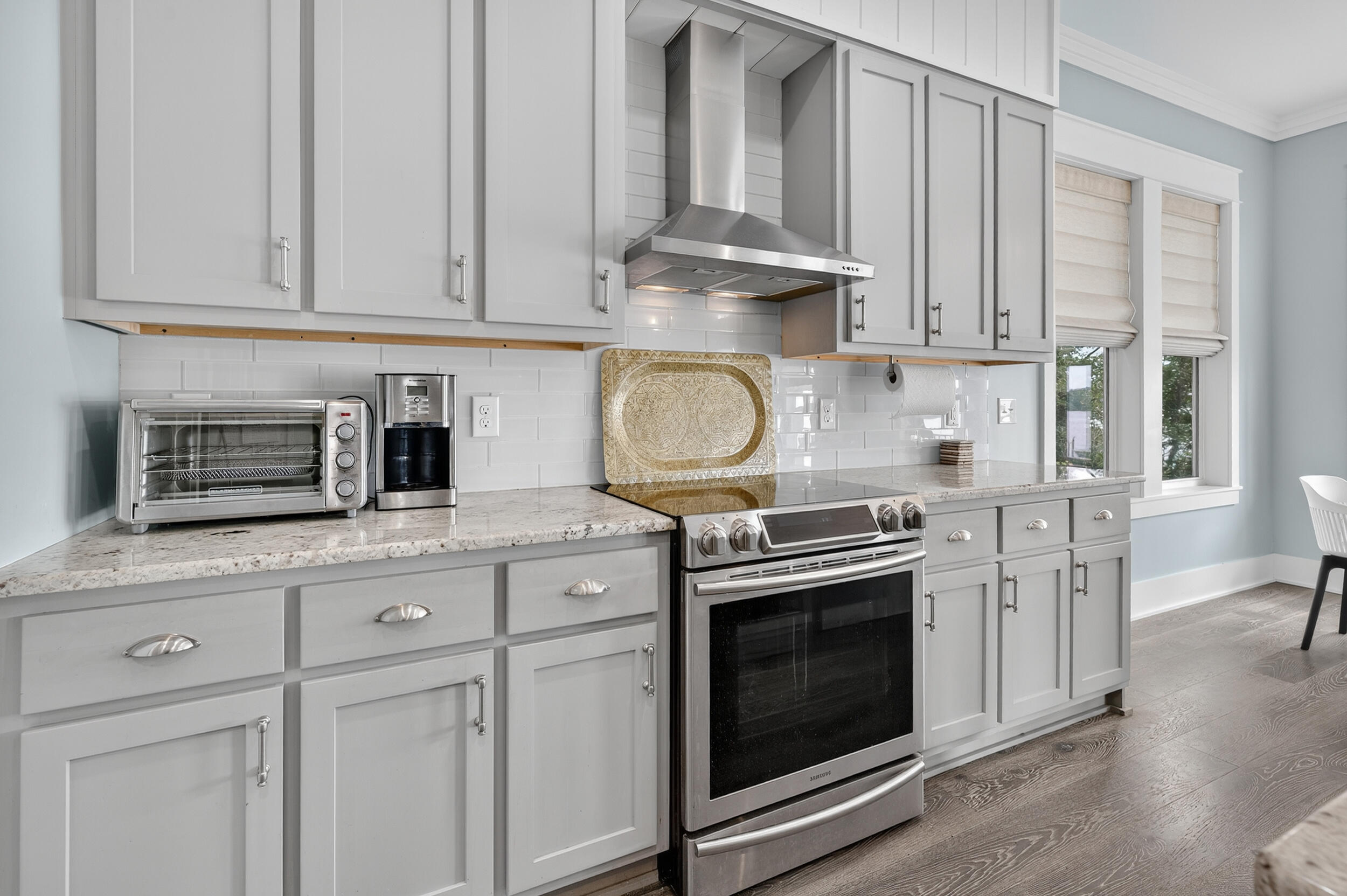 2975 Holley Point Road Navarre, FL 32566 - Photo 34 of 101 a kitchen with stainless steel appliances granite countertop a stove a sink and a white cabinets